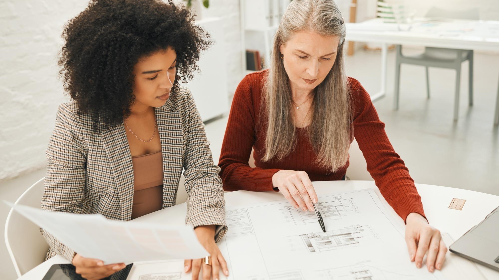 Business women blueprint and home design with floor plan and teamwork for construction meeting Management collaboration and paperwork for house layout and renovation drawing in creative office