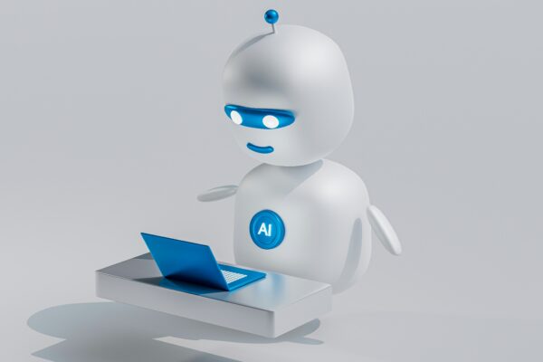 a white robot with blue eyes and a laptop