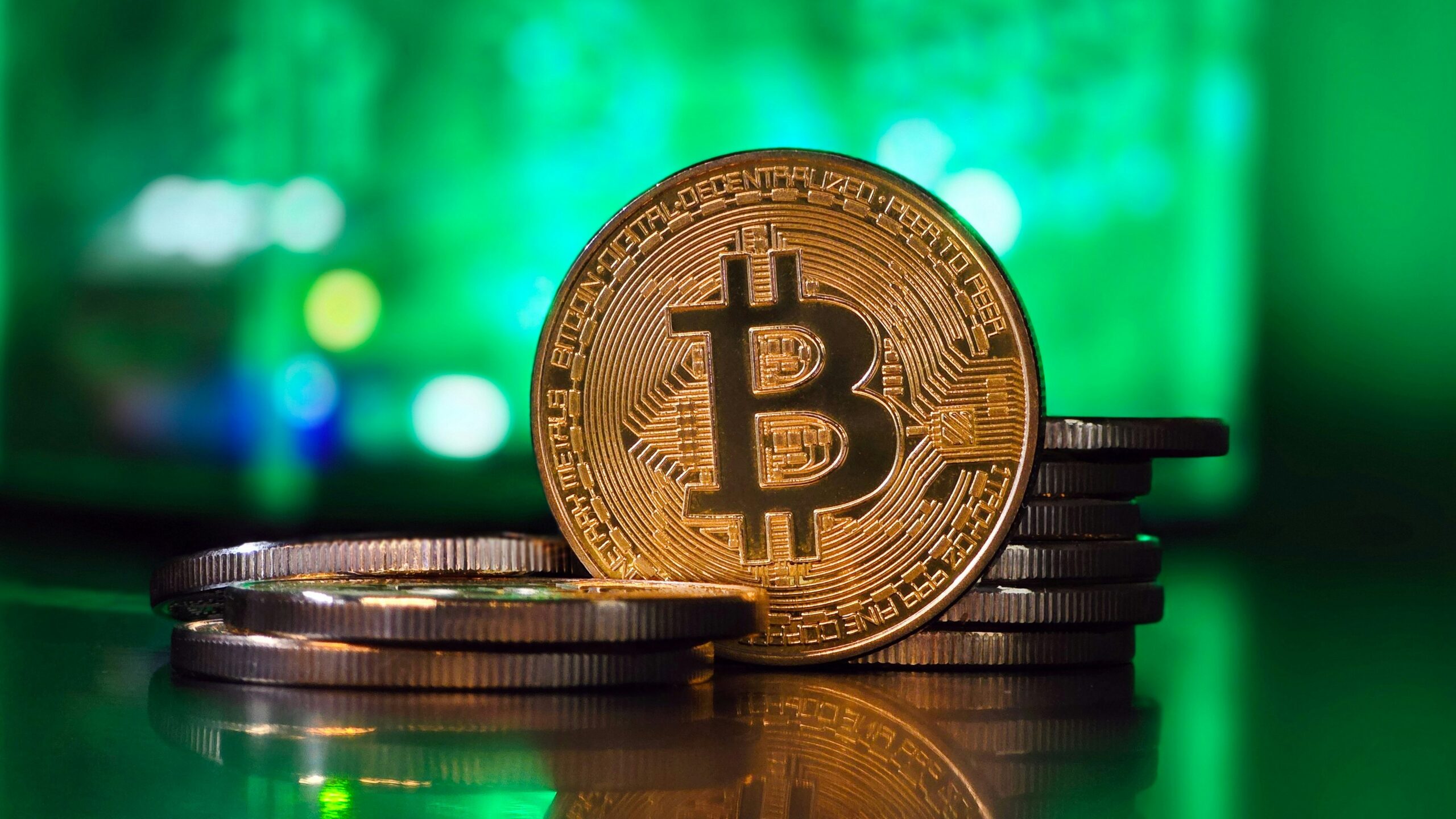 a bit coin sitting on top of a stack of coins
