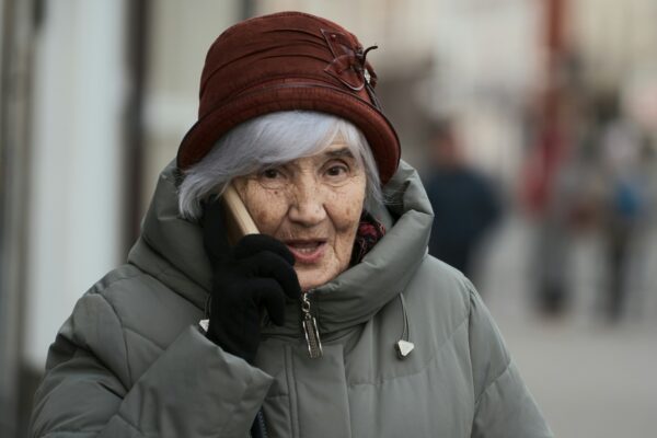 Elderly woman talking on a mobile phone.