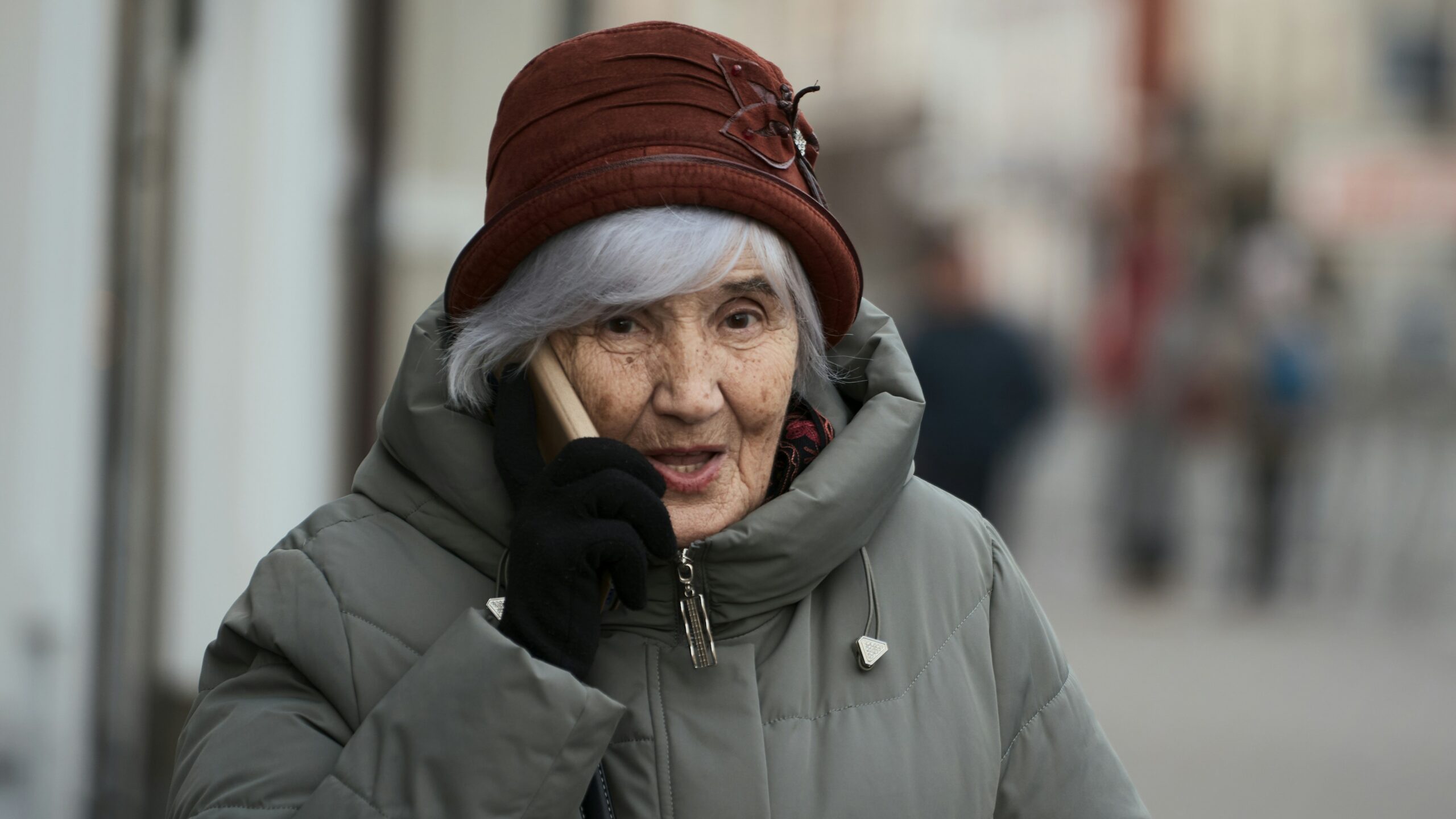 Elderly woman talking on a mobile phone.