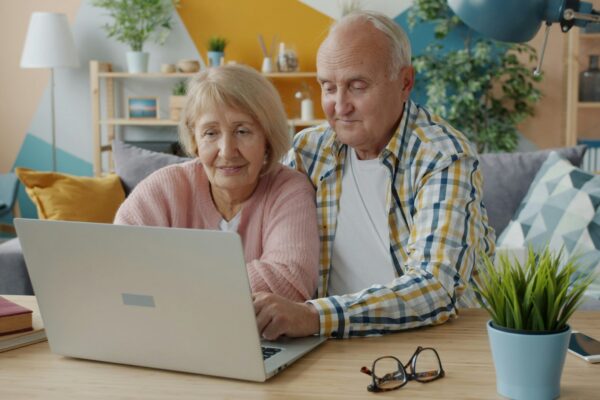 Elderly couple looking at a laptop together