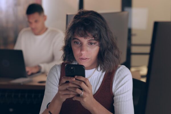 Smartphone office and business woman with social media networking feedback and online review of data analytics seo and app management Focus typing and digital marketing worker on cellphone chat