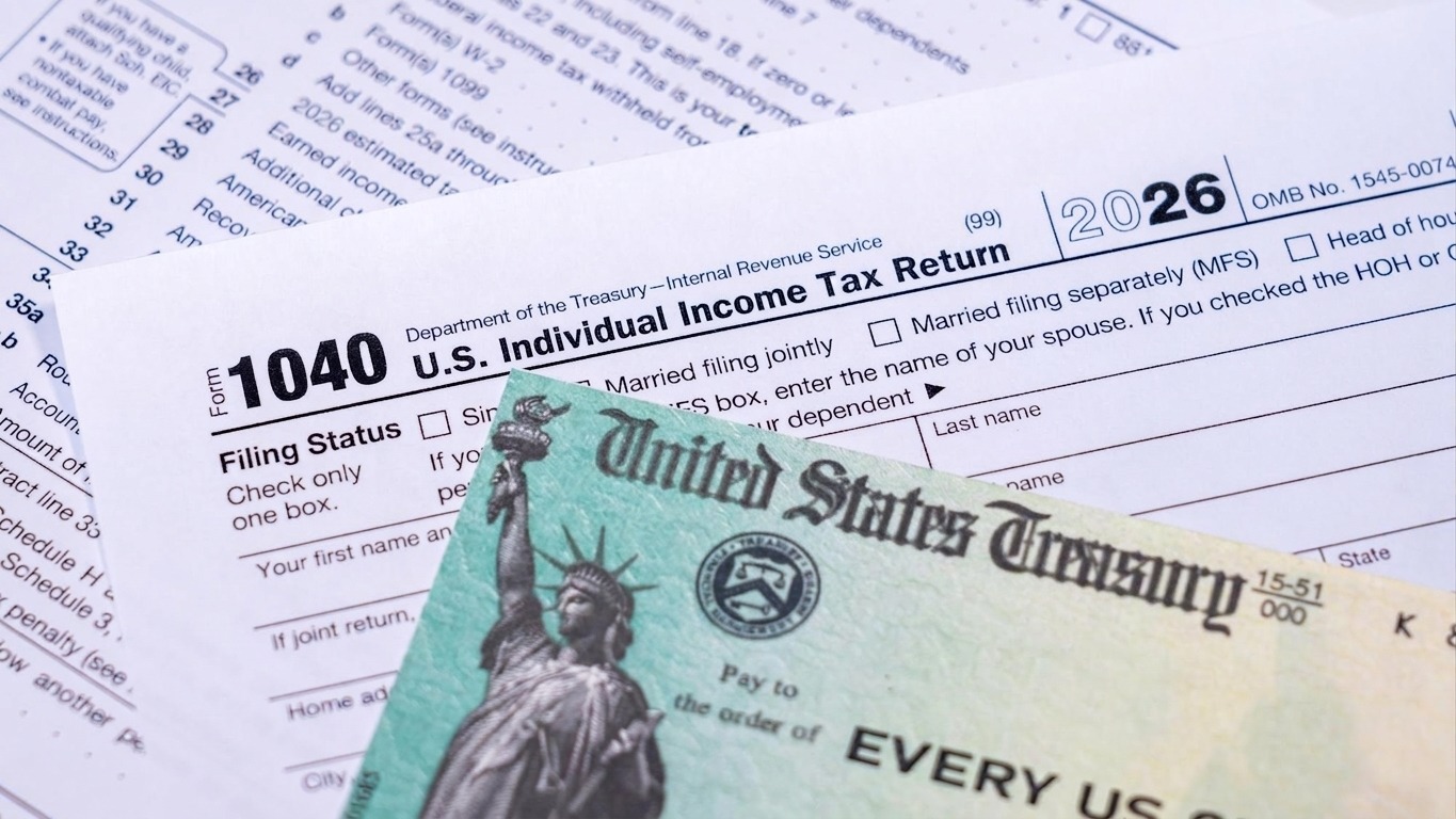 US Treasury stimulus check laying on a form 1040 tax return for 2020 to illustrate questions about qualification for payment
