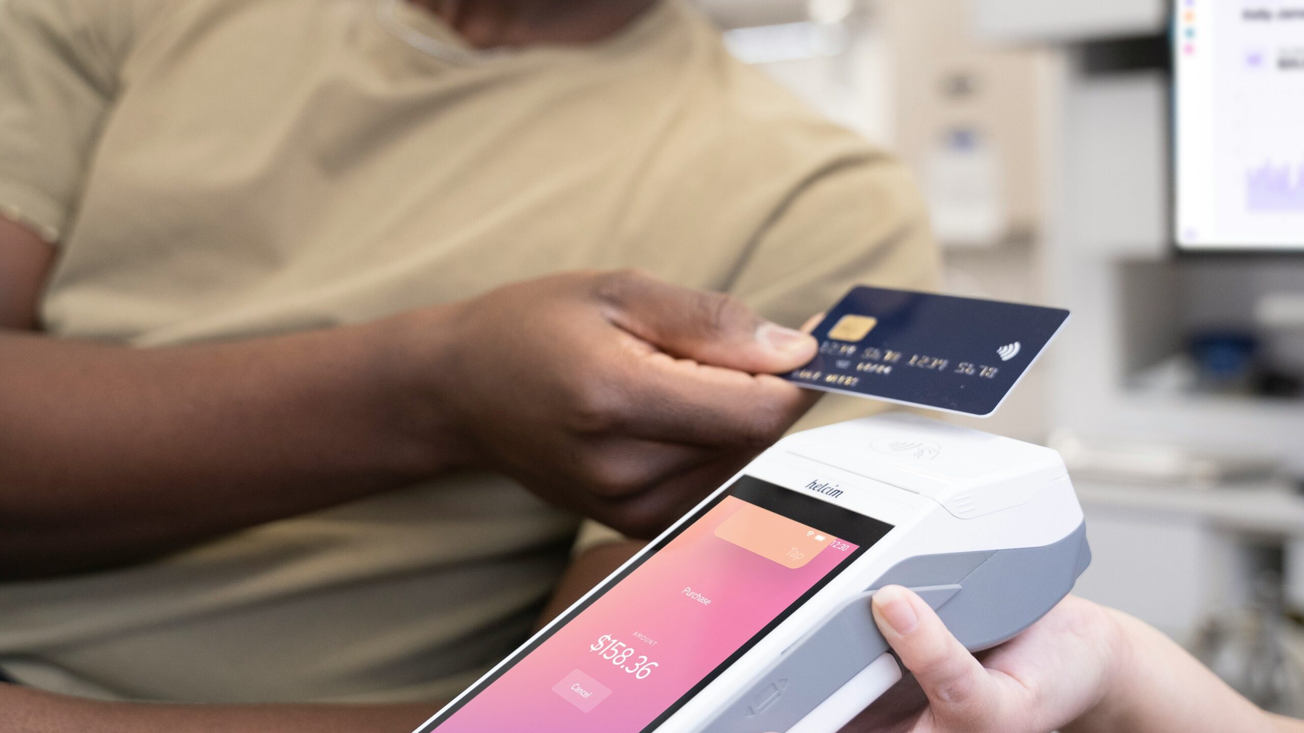 a person holding a credit card and a cell phone