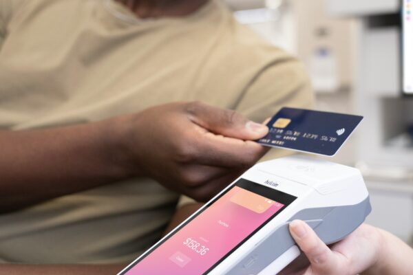 a person holding a credit card and a cell phone