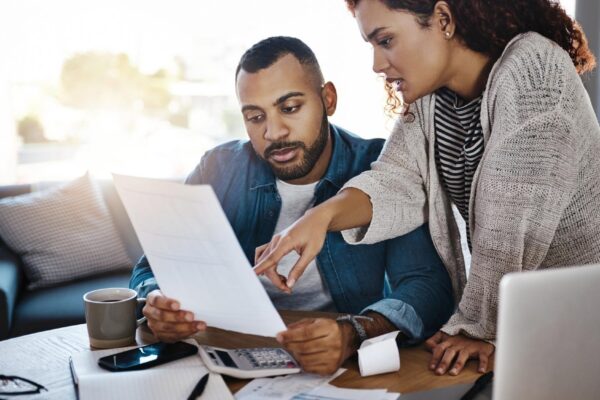 Talking finance budget or couple with invoice paperwork or taxes documents for planning savings Investment rent or people organizing bills checklist for paying debt or financial household expenses