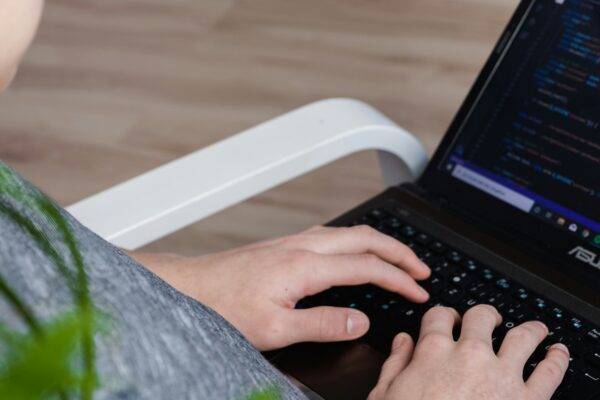 person using black Asus laptop