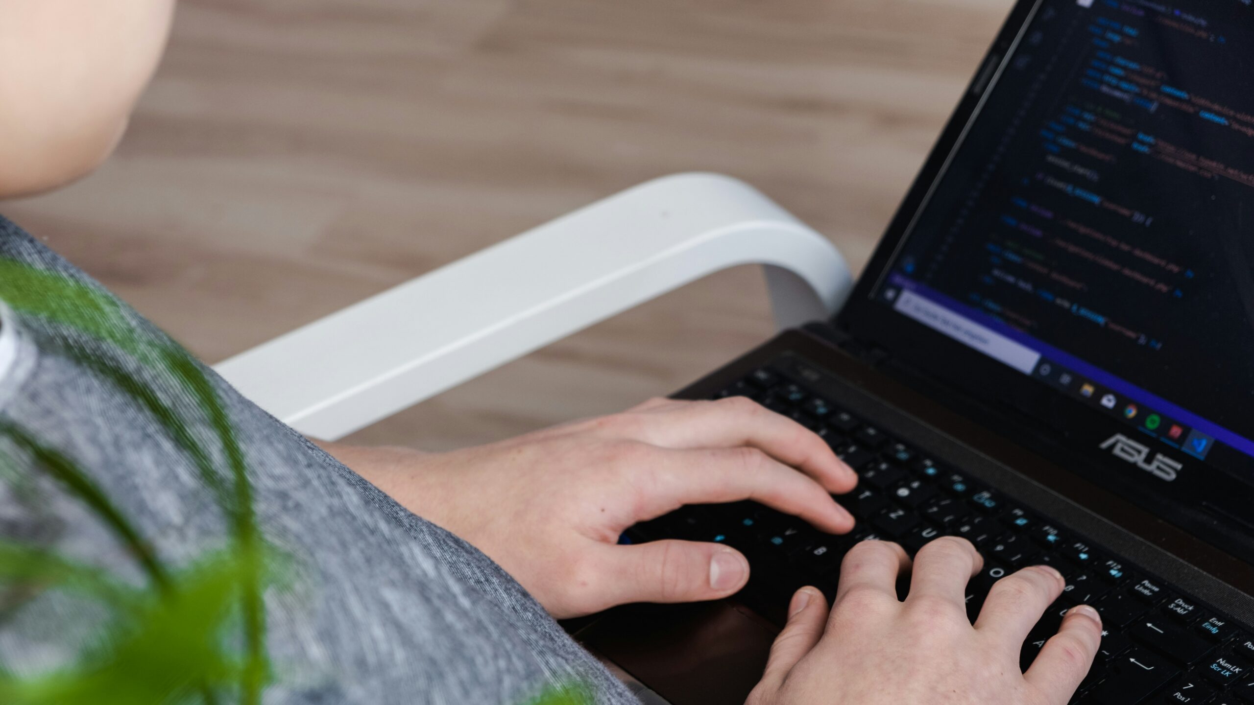 person using black Asus laptop