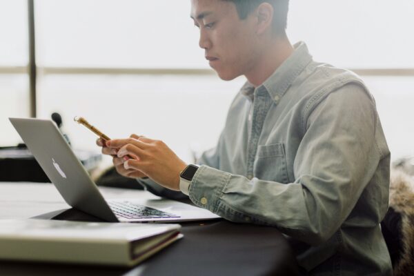 a man sitting in front of a laptop computer