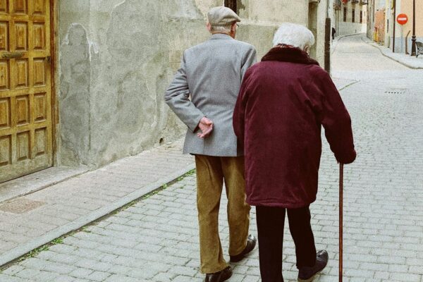 man and woman walking near closed wooden door