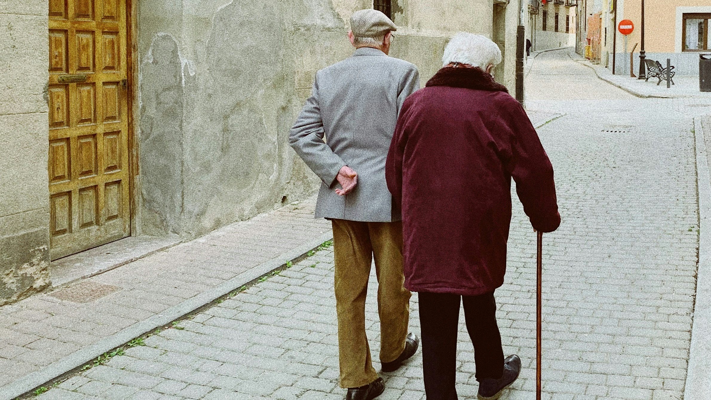 man and woman walking near closed wooden door