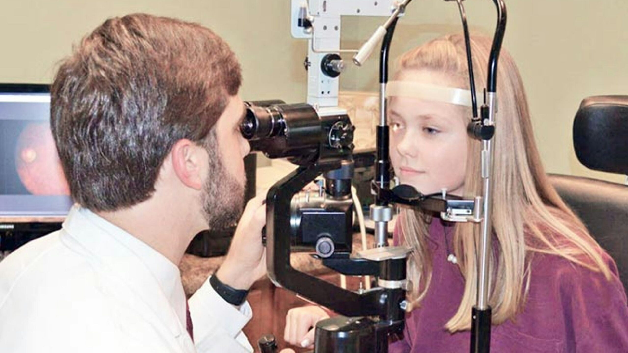 A man and a woman looking through a camera