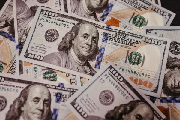 a pile of twenty dollar bills laying on top of each other