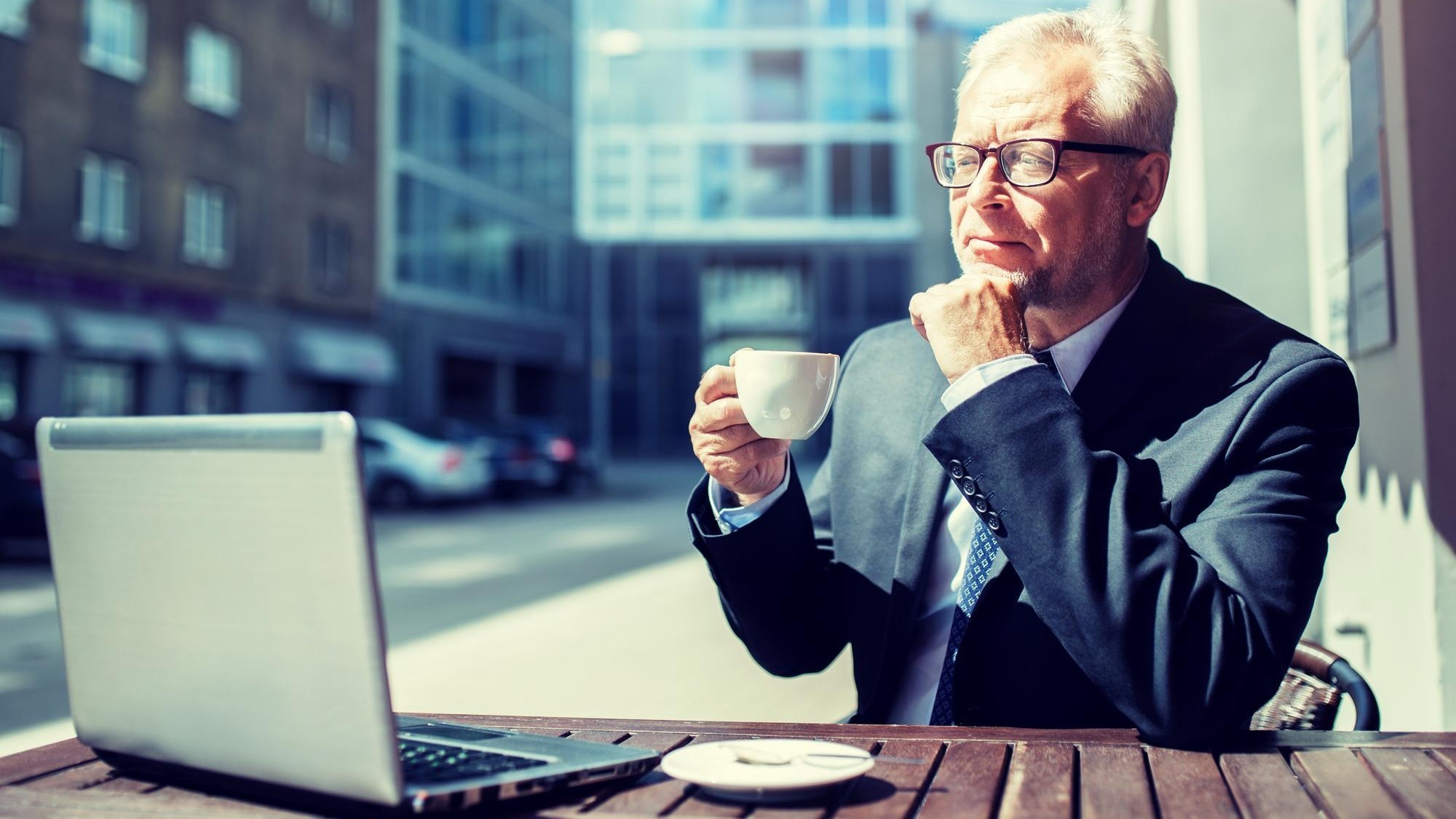 senior businessman with laptop drinking coffee