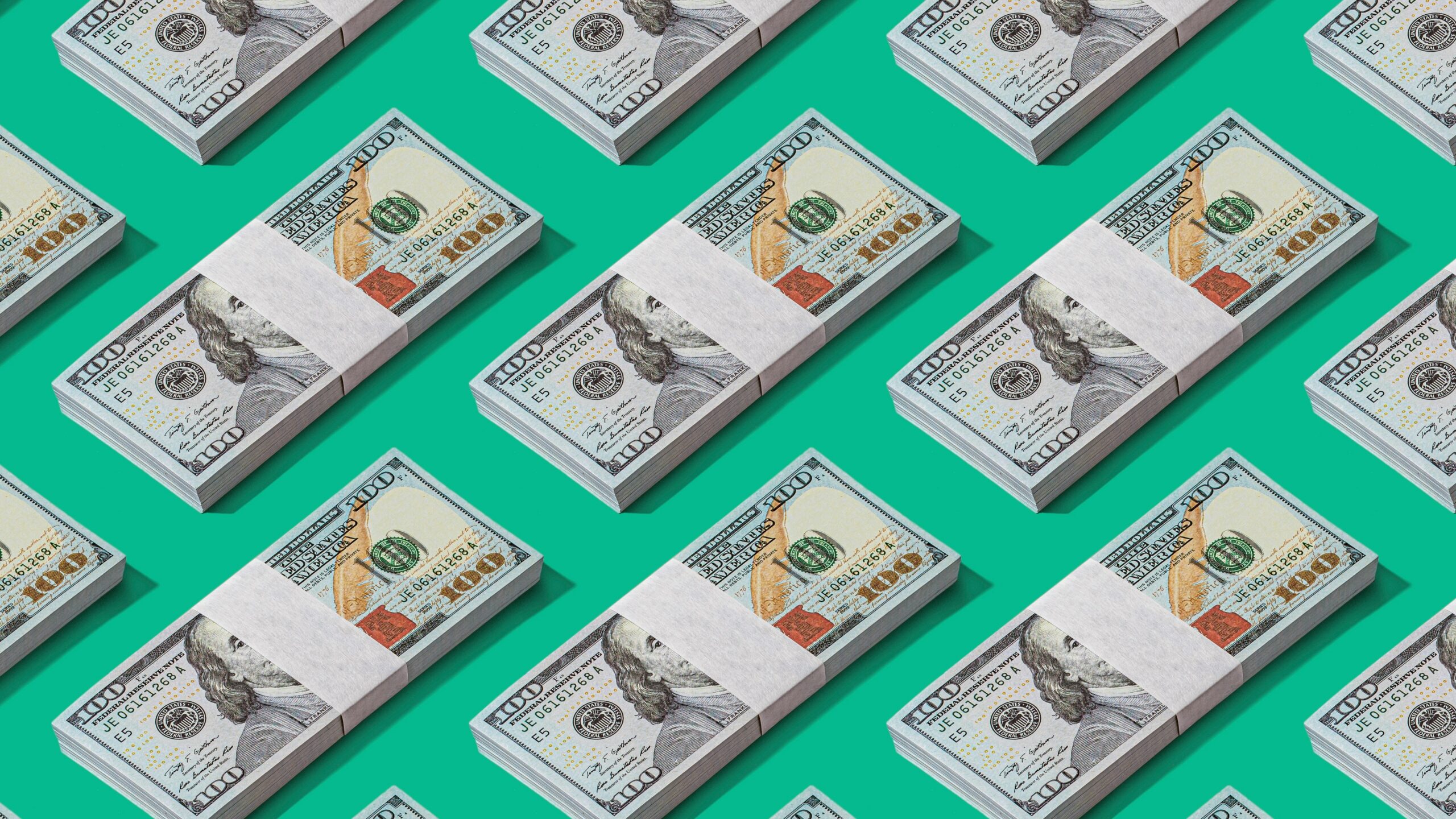 a lot of money sitting on top of a green surface