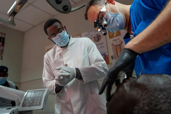 U.S. Army Maj. Bryant Farr, an endodontist assigned to Dental Health Activity Bavaria, examines the mouth of a patient during the medical readiness exercise (MEDREX) at the 37th Military Hospital in Accra, Ghana, May 19, 2025. Part of African Lion 2025 (AL25), this MEDREX is planned and executed by U.S. Army Southern European Task Force, Africa (SETAF-AF), and prepares U.S. military health professionals for the challenges of providing care outside of traditional clinical settings. By working alongside African partners, U.S. medical professionals refine their ability to deliver rapid, adaptable, and resource efficient medical care, directly increasing medical readiness for large scale combat operations. AL25, the largest annual military exercise in Africa, will take place from April 14 to May 23, 2025. Led by SETAF-AF, on behalf of U.S. Africa Command with over 10,000 troops from more than 50 nations, including seven NATO allies, across Ghana, Morocco, Senegal, and Tunisia. The exercise aims to bolster military readiness, enhance lethality, and foster stronger partnerships, ultimately improving joint capabilities in complex multi-domain environments to enable participating forces to deploy, fight, and win. (U.S. Army photo by 1st Lt. Katherine Sibilla)