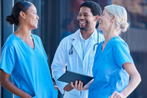 Diversity teamwork and healthcare a team of doctors talking and laughing outside a hospital A happy black doctor and women nurses having a conversation A group of medical employees during a break