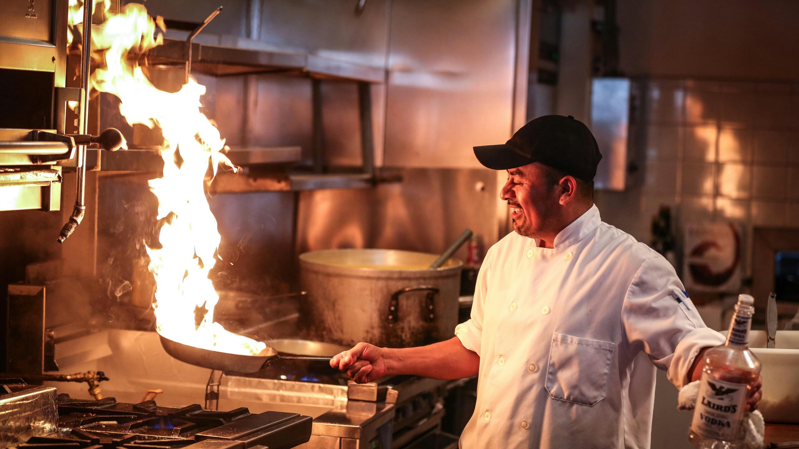 man in white chef uniform cooking