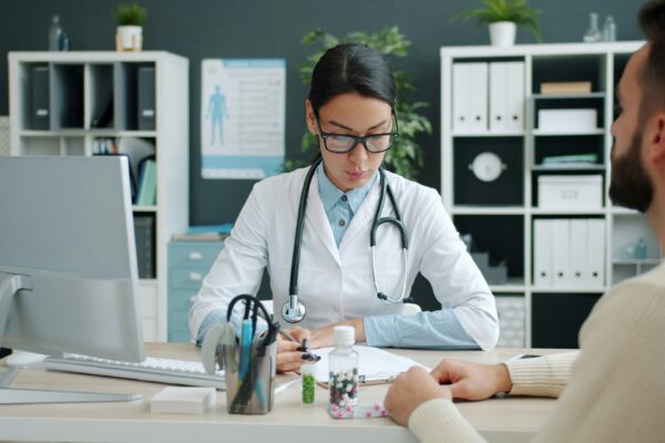 Doctor consulting with patient at desk