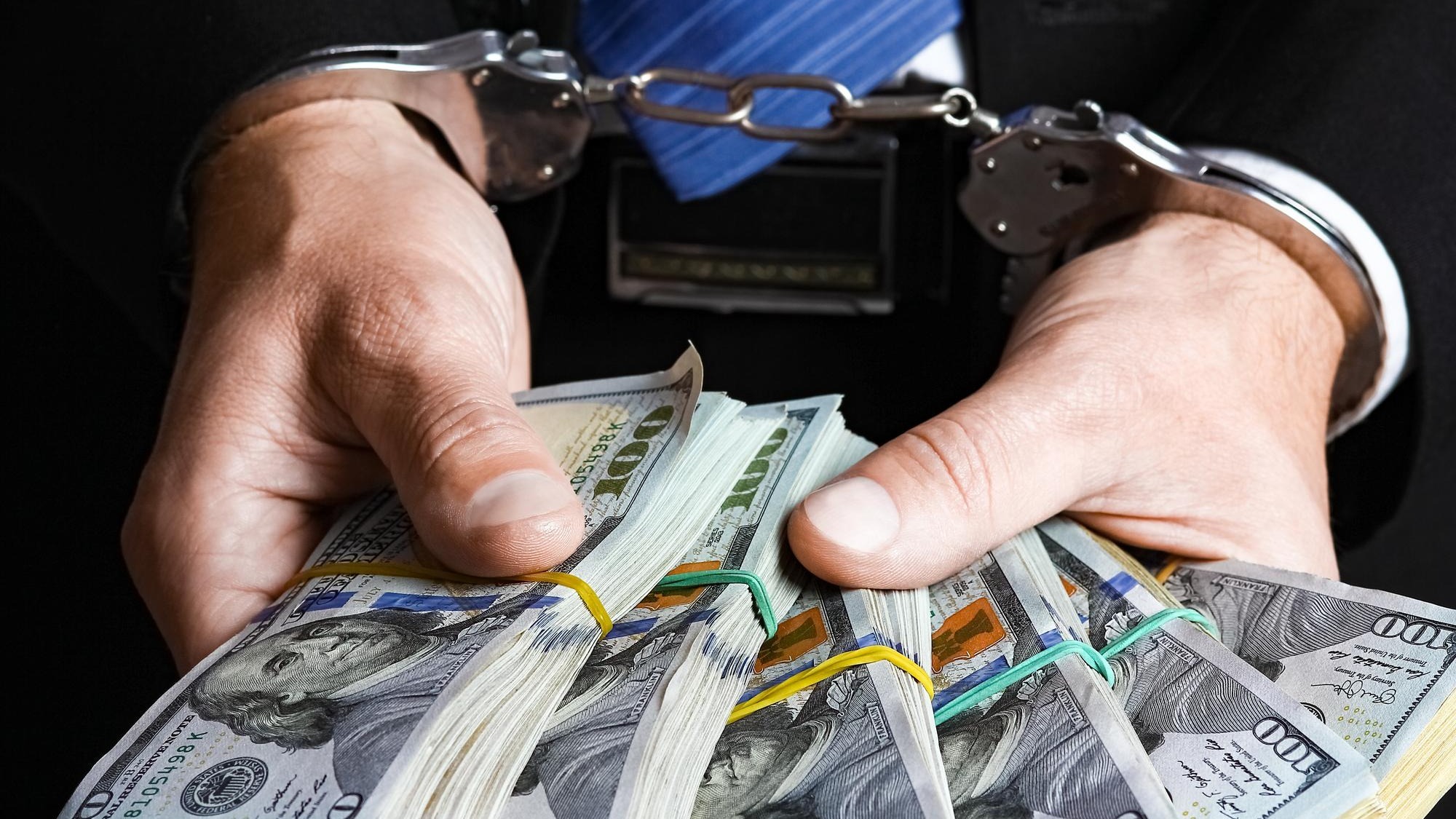 A money in the hands of a businessman crime in a crisis raising business concept bank worker