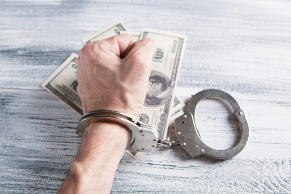 person holding silver ring on 100 us dollar bill