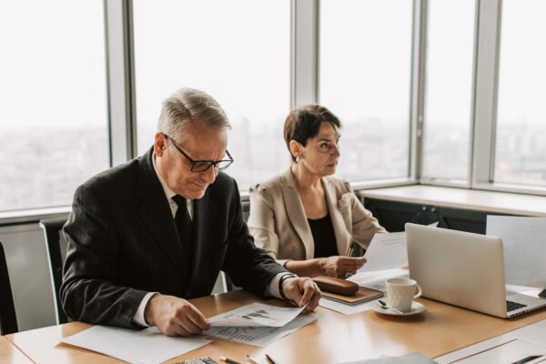 Corporate meeting with professionals discussing documents in a modern office.