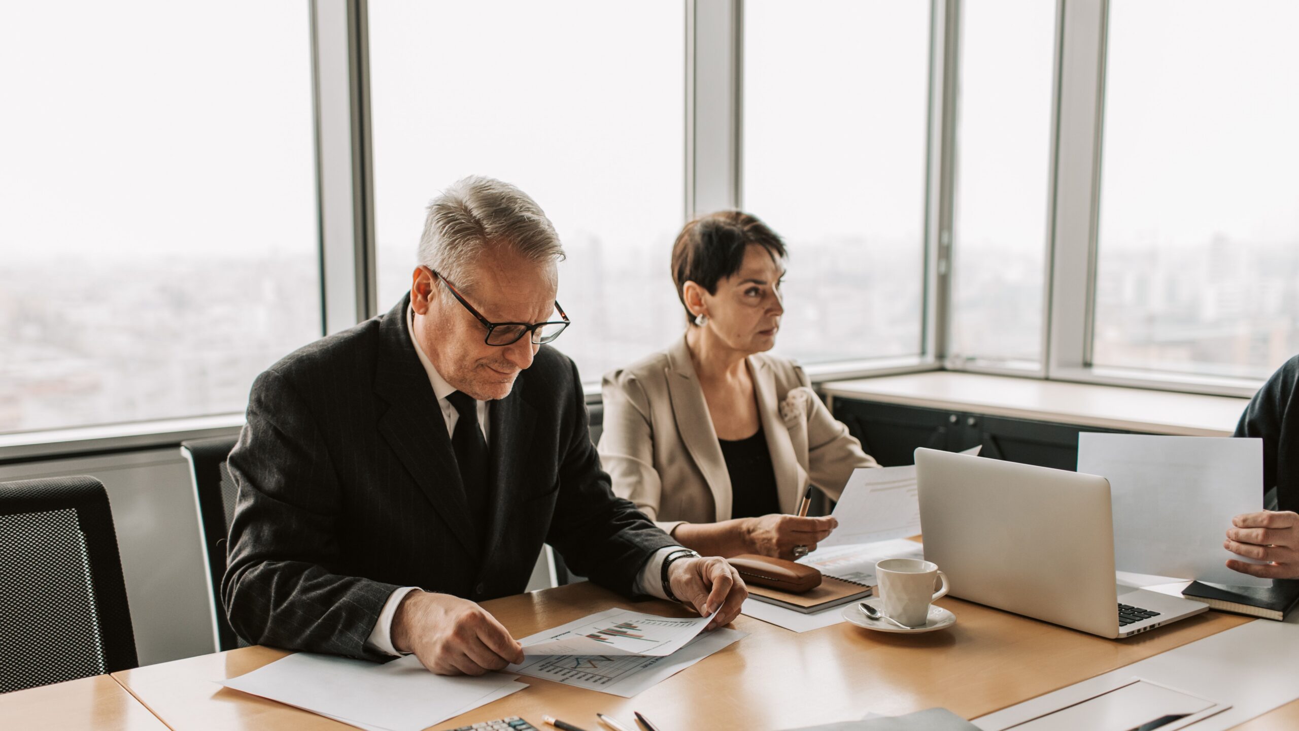 Corporate meeting with professionals discussing documents in a modern office.