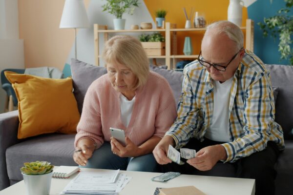 Elderly couple managing finances at home