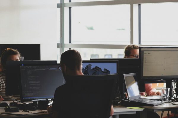people sitting on chair in front of computer monitor