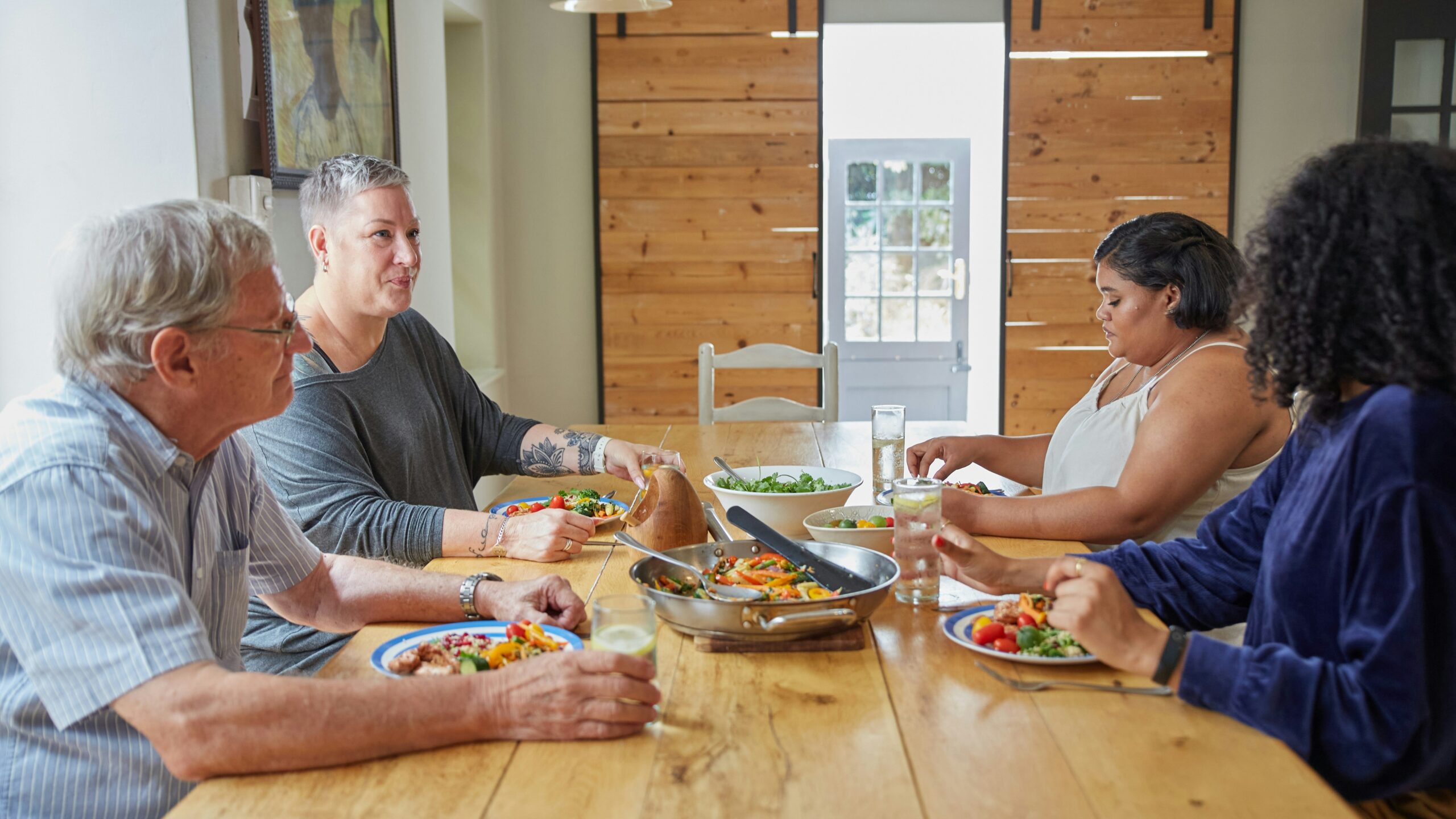 a group of people sitting around a table eating food