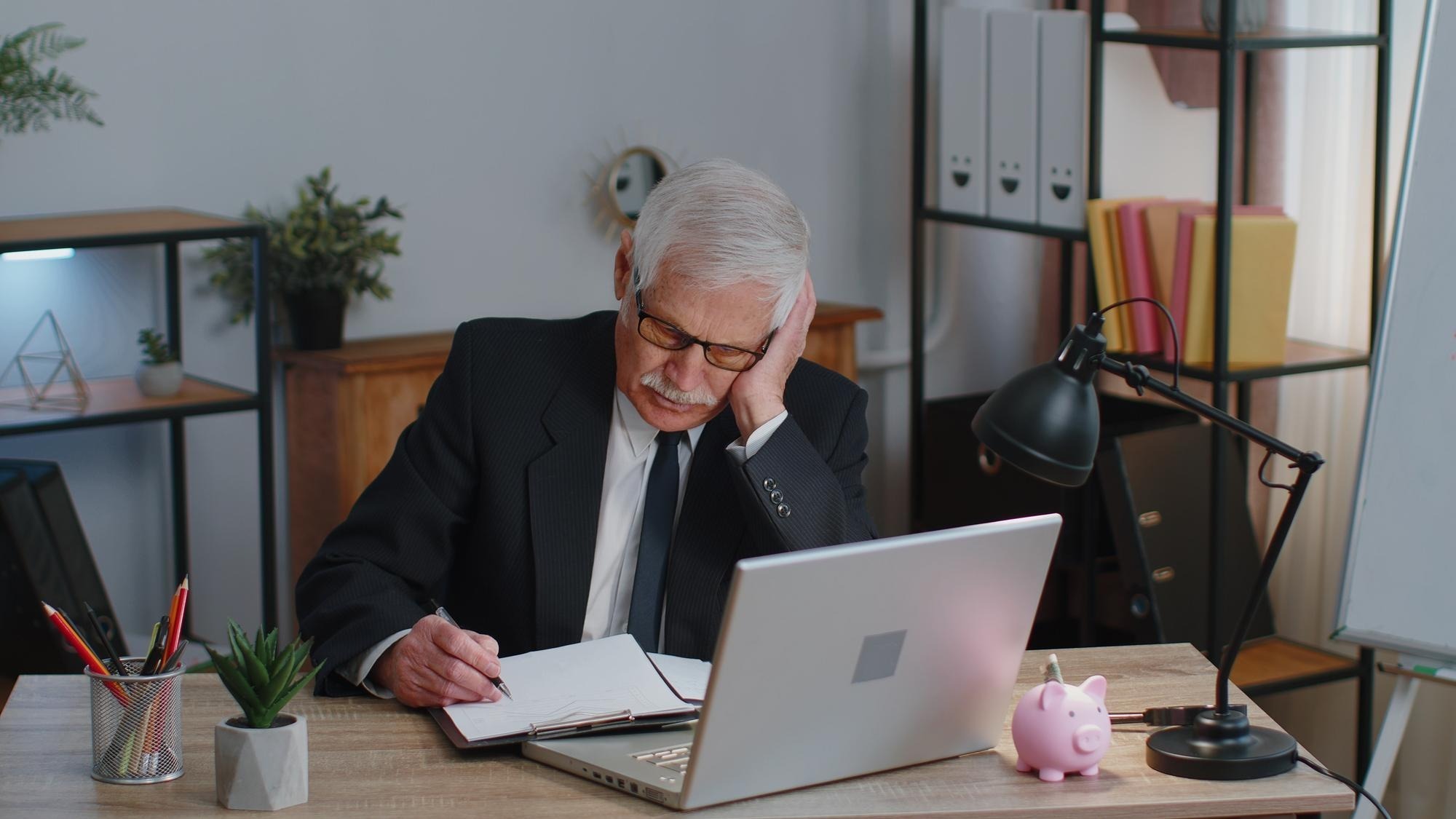 Portrait of young man using laptop at table