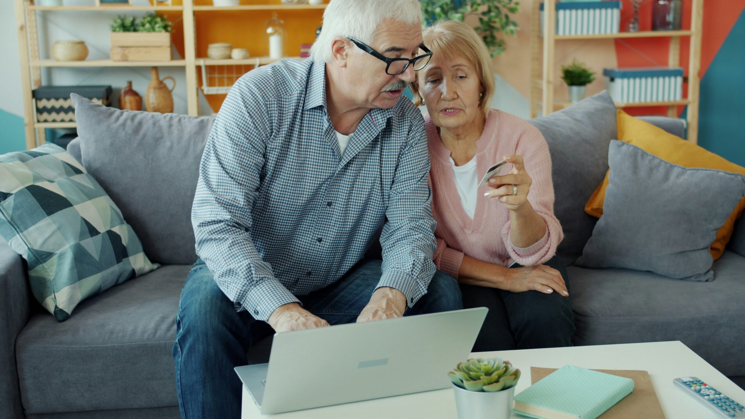 Elderly couple looking at a laptop together