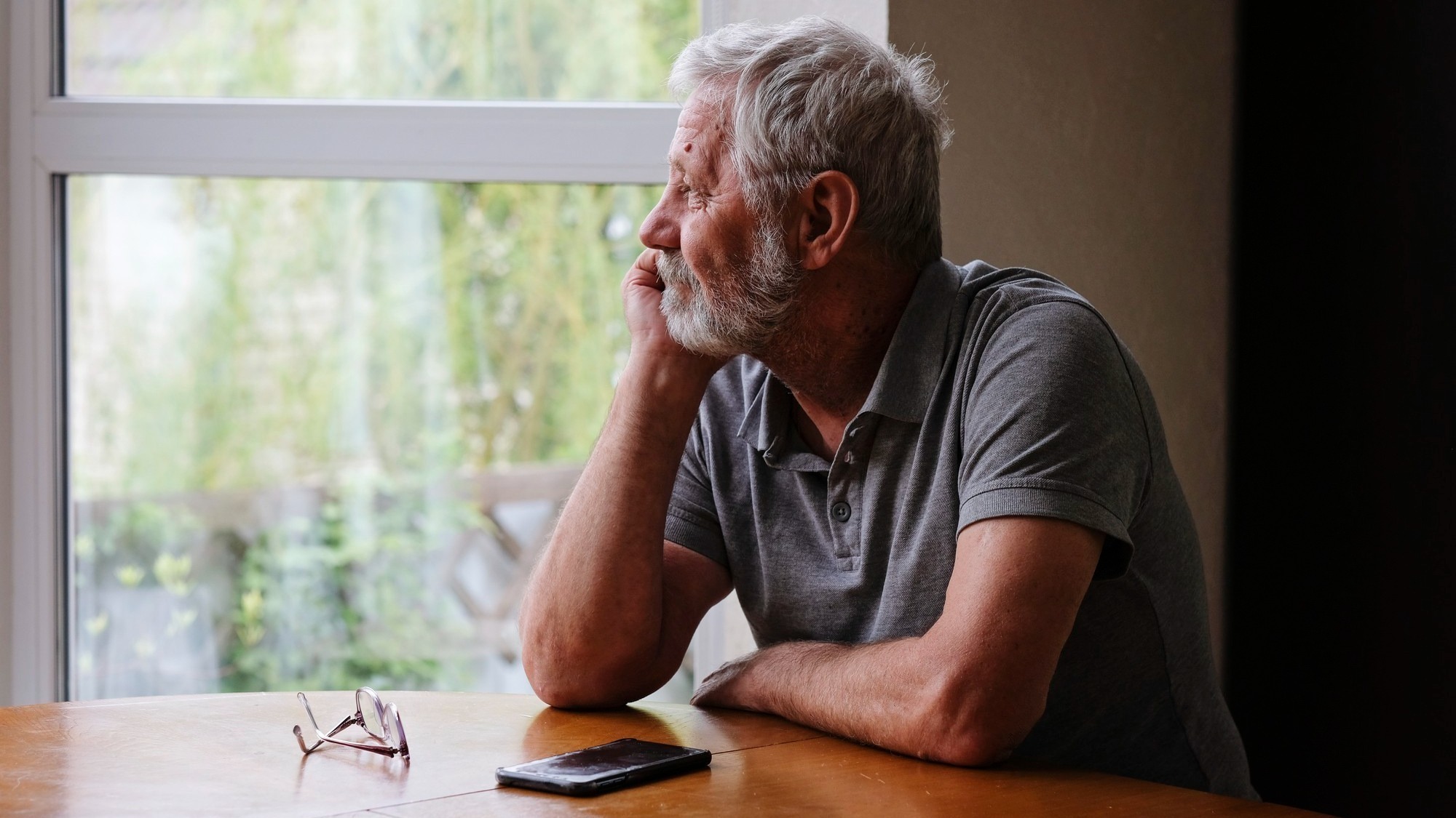 Senior retired man sitting at home alone while quarantine