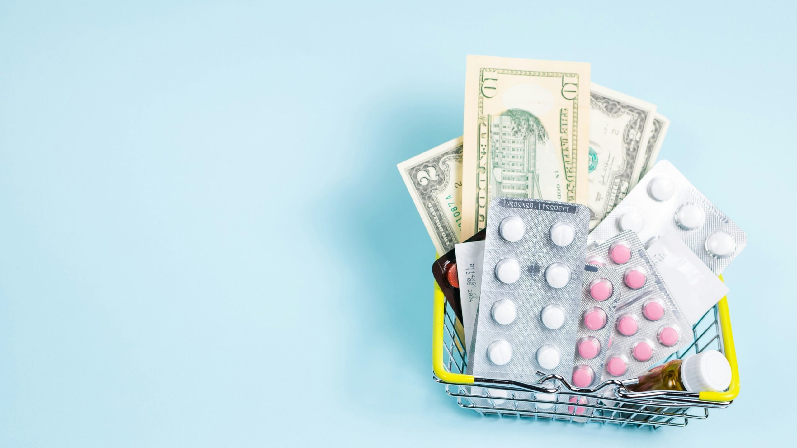 a shopping cart filled with pills and money