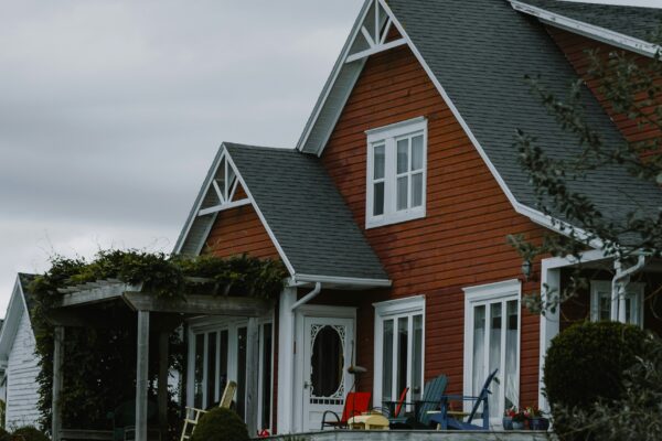 a house with a lawn and flowers in front of it
