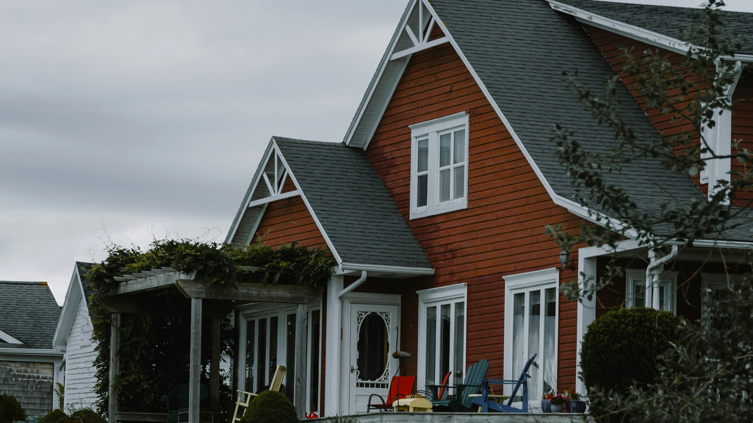 a house with a lawn and flowers in front of it