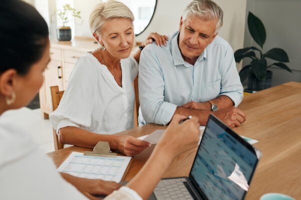 Financial advisor consultation with clients on retirement finance planning or investment and document on laptop screen Accountant woman senior people and pension advice asset management or budget