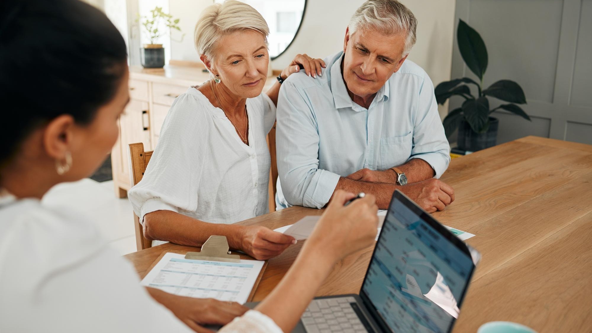 Financial advisor consultation with clients on retirement finance planning or investment and document on laptop screen Accountant woman senior people and pension advice asset management or budget
