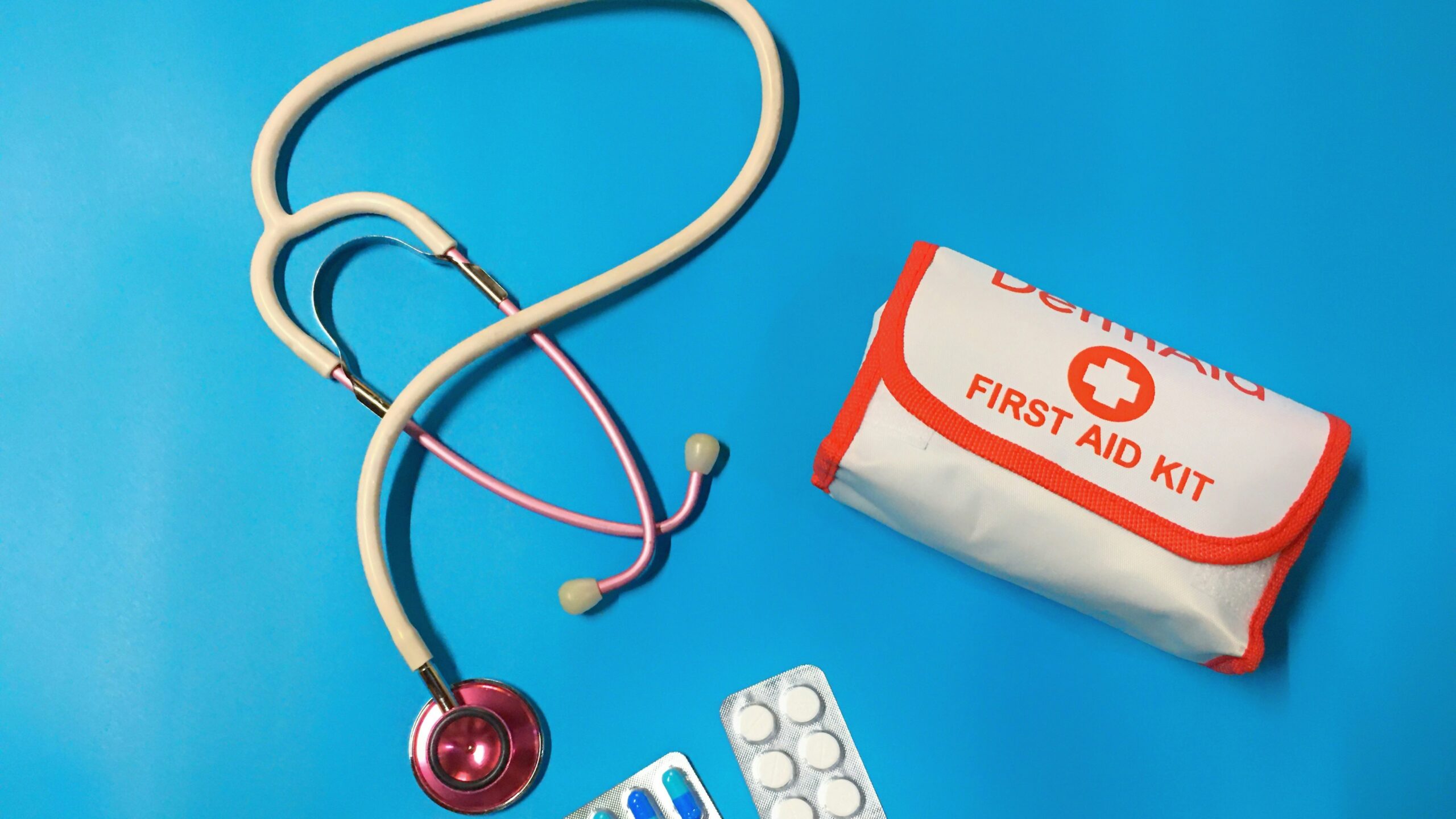 a bag of pills, a stethoscope, and a first aid kit
