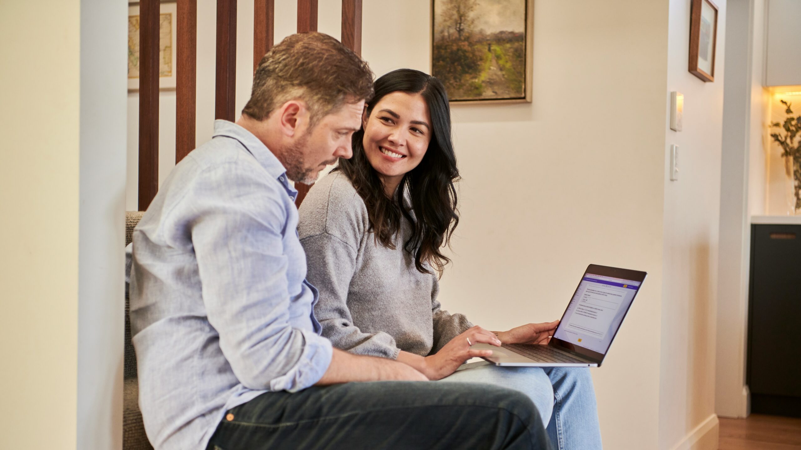 man sitting beside woman looking at a contract on DocuSign