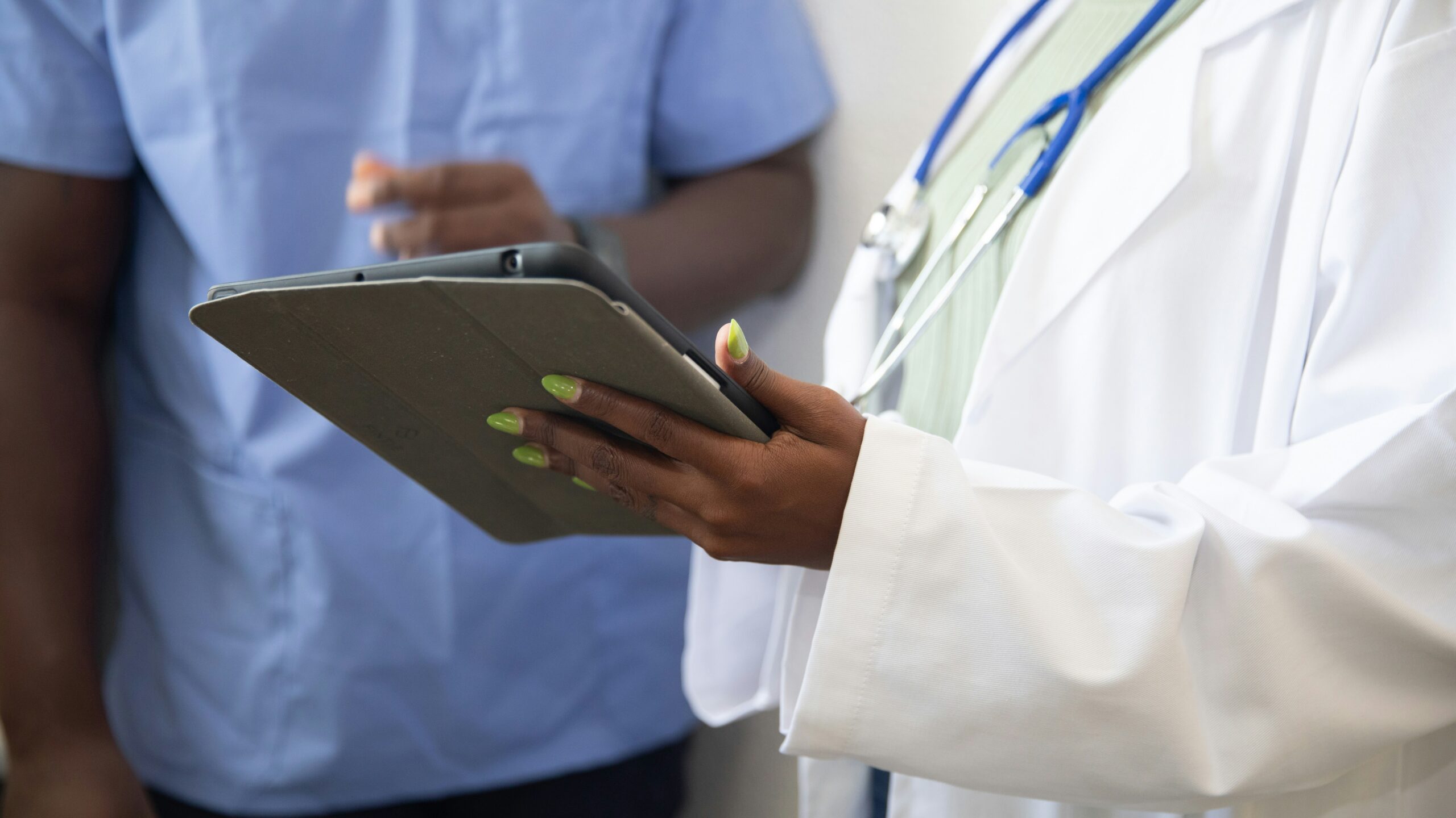 a doctor showing a patient something on the tablet