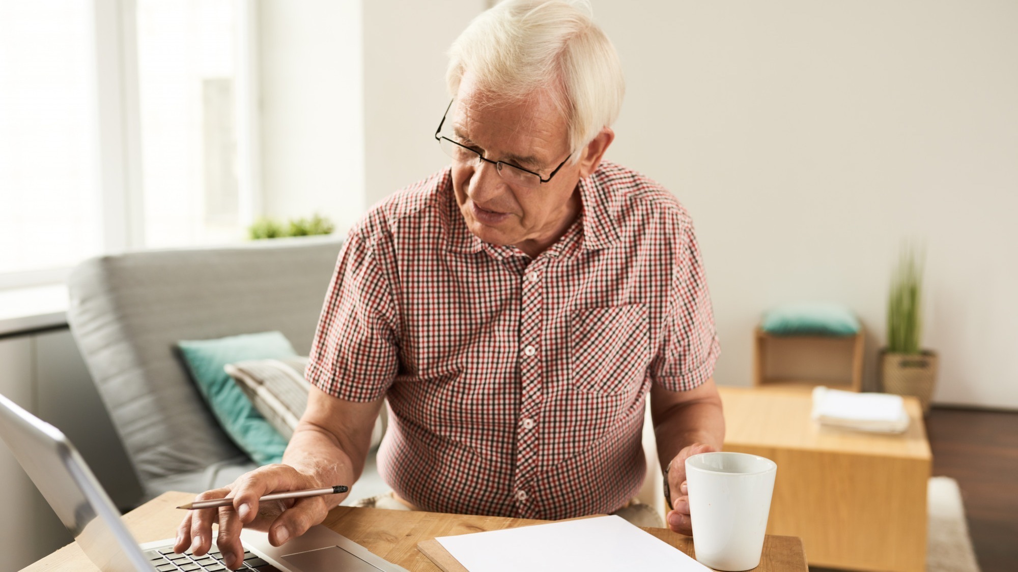 Senior Man Working with Laptop at Home