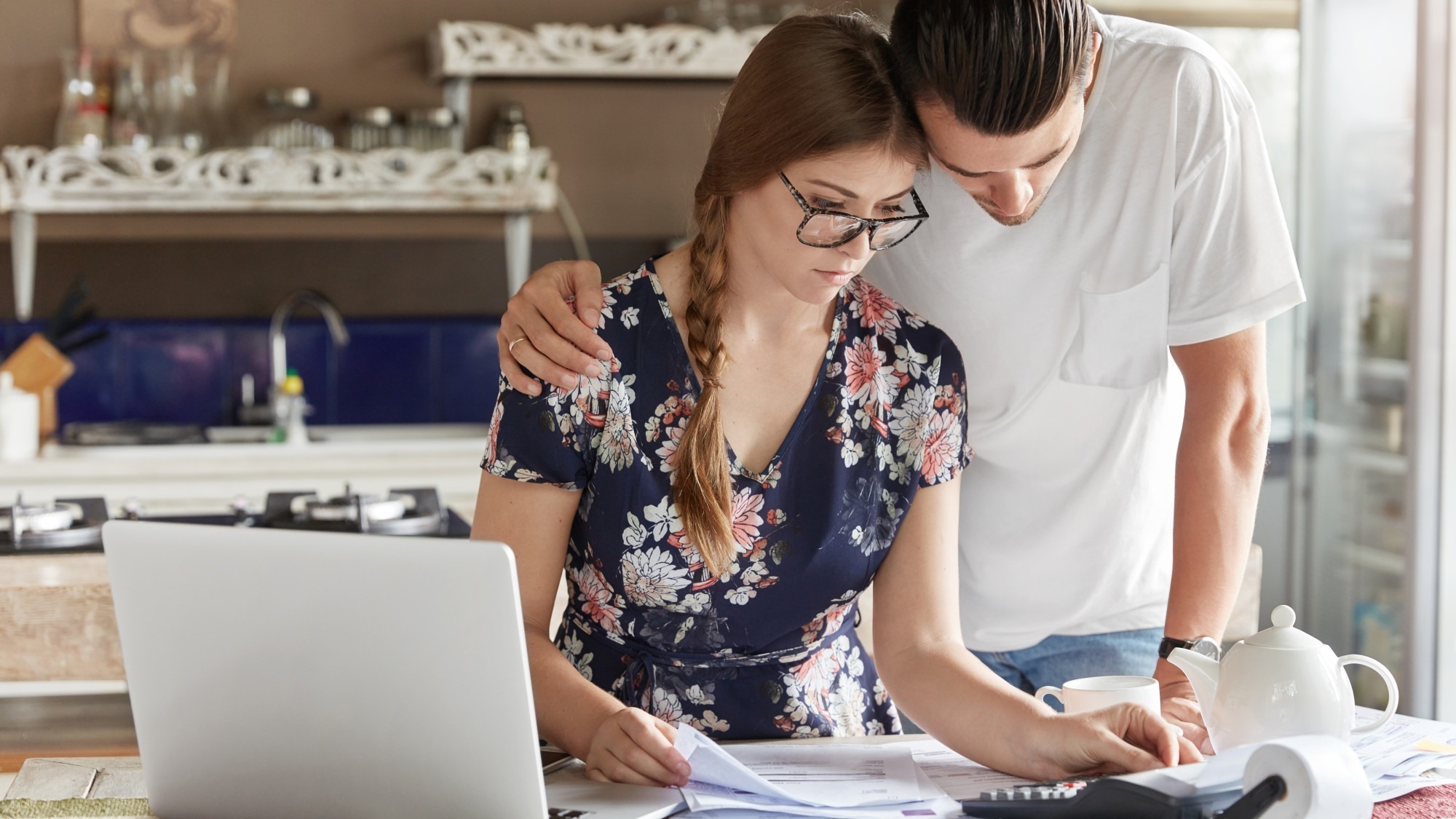 Couple managing budget together in kitchen