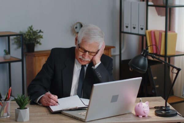 Portrait of young man using laptop at table