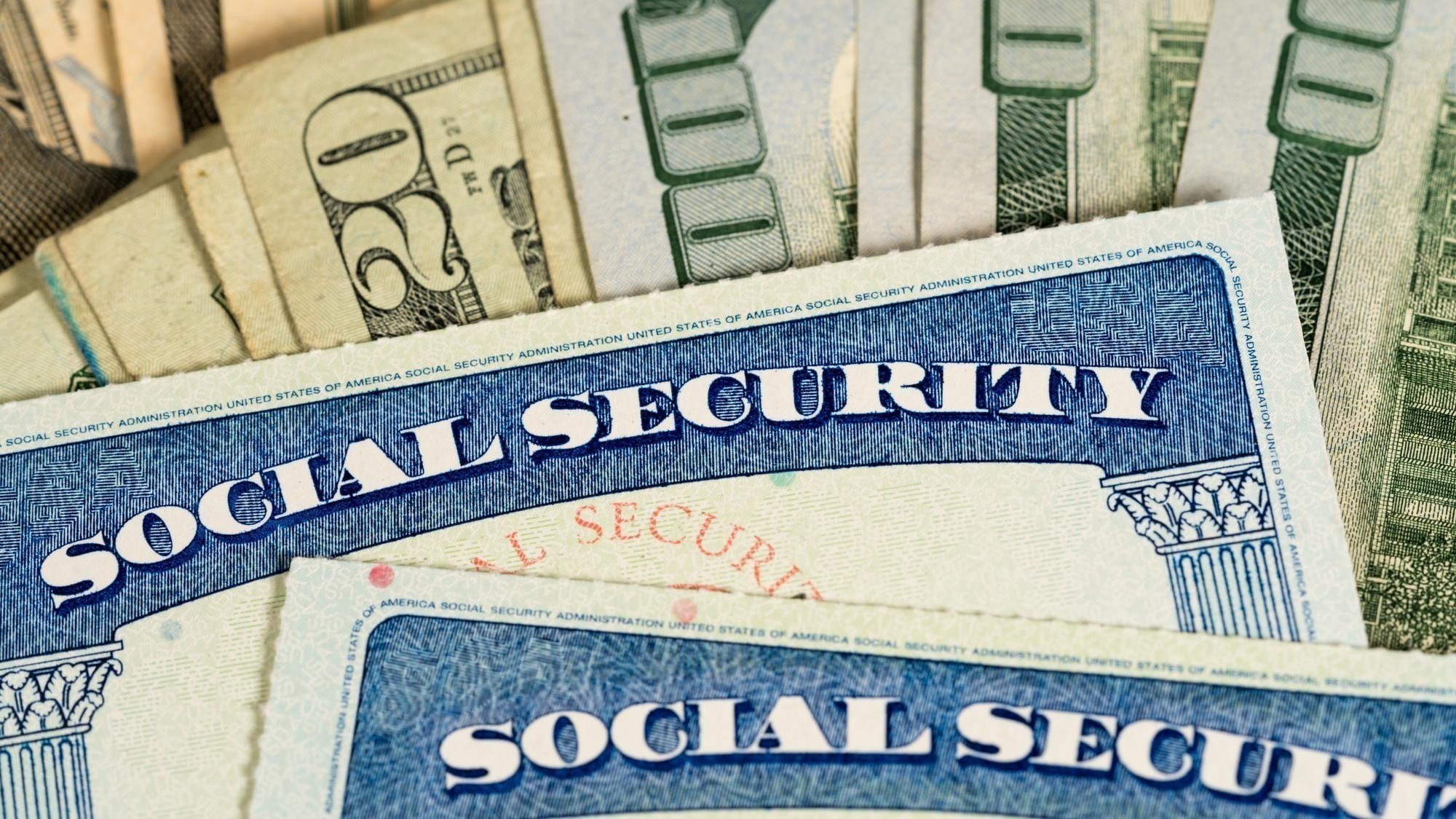 USA Social security cards laid on dollar bills