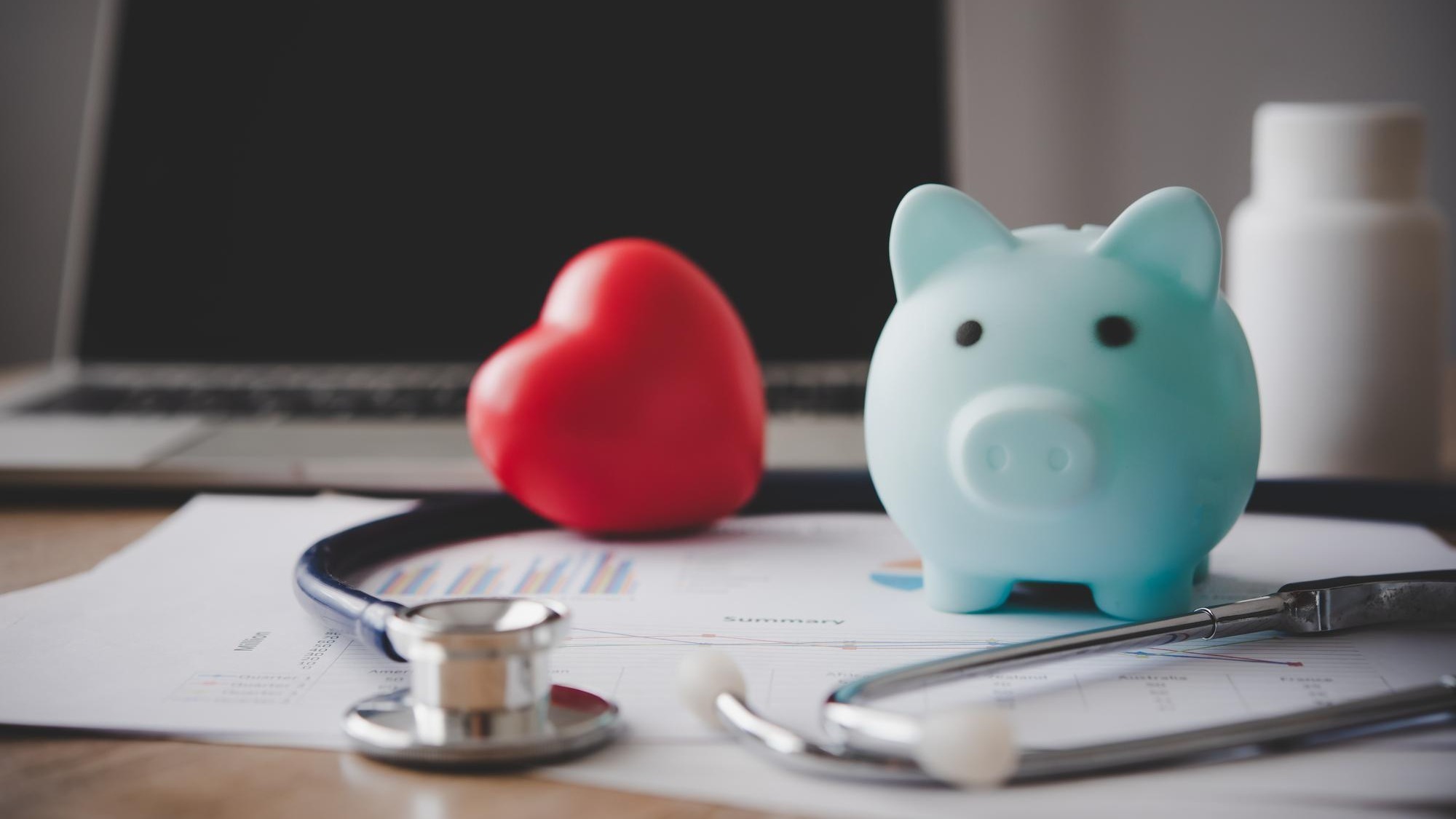 Medical Insurance Concept With Piggy Bank And Stethoscope On Wooden Desk