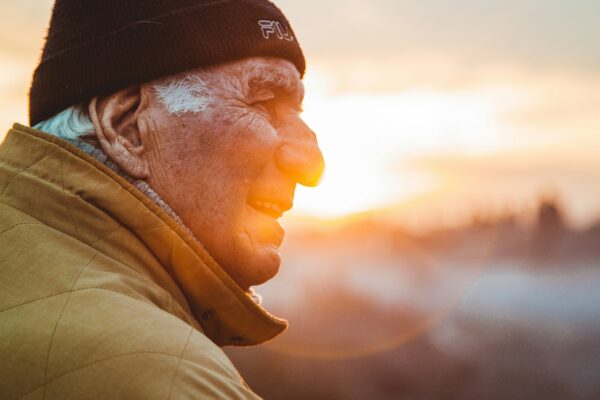 man wearing brown jacket and knit cap