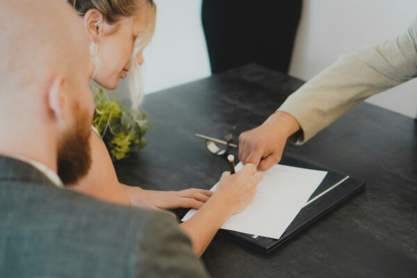 couple signing document at desk