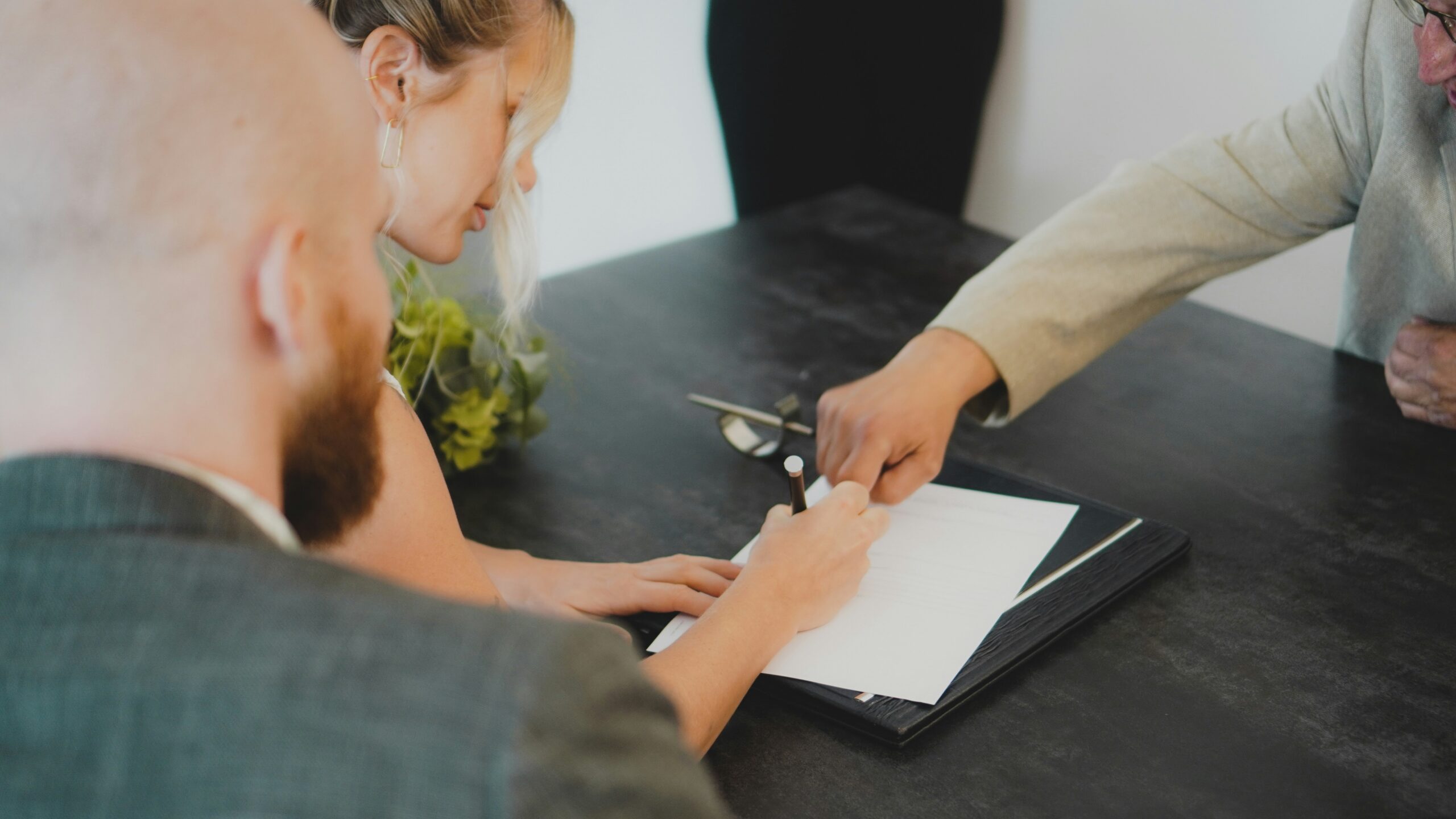 couple signing document at desk